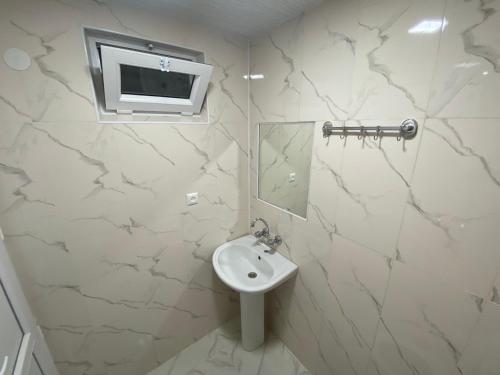 库塔伊西Guesthouse LUKA的白色的浴室设有水槽和镜子