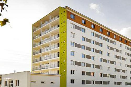 NivyModerný apartman s parkovaním的黄色的高公寓楼