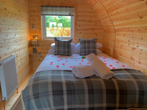 KeltyPond View Pod 3 With Private Hot Tub - Pet Friendly -Fife - Loch Leven - Lomond Hills的小木屋内一间卧室,配有一张床