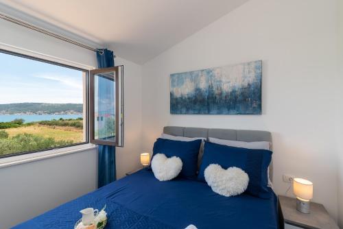 卡斯特尔·斯塔费力克Amazing sea view apartment- Romantica的一间卧室设有一张蓝色的床和大窗户