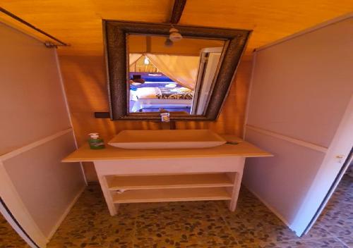 梅尔祖卡Luxury Desert Romantic Camp的一间带水槽和桌子镜子的浴室
