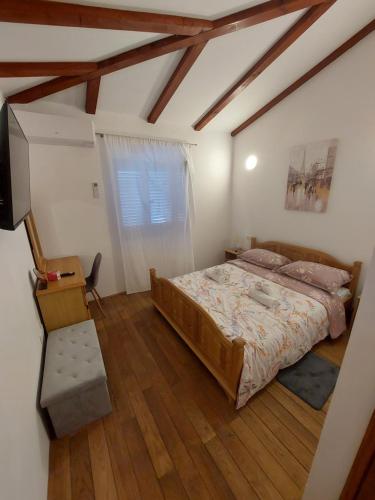 波雷奇Casa Vežnaveri的一间卧室配有一张床、一张书桌和一台电视