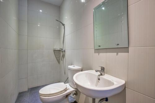 棉兰Vivostay的白色的浴室设有卫生间和水槽。