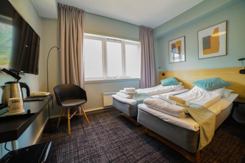 Øvre ÅrdalSitla Hotel & Appartments的酒店客房配有两张床和一张书桌