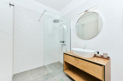 乌马格Apartments San Maris 2的一间带水槽和镜子的浴室
