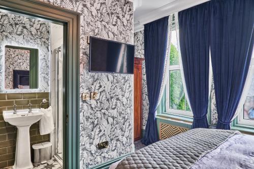 伦敦德里The Lawrence的一间卧室配有床、水槽和镜子