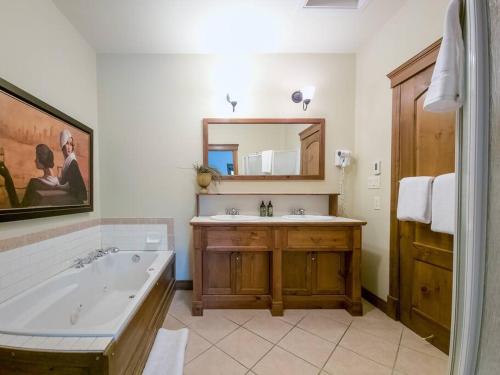 蒙特朗布朗Manoir 108-2/ Perfect getaway with POOL的带浴缸、水槽和镜子的浴室