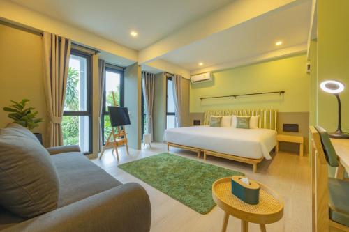 普吉镇Chamemon Bed Phuket Town的酒店客房,配有床和沙发