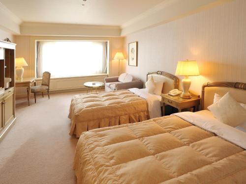 普瑞米尔米诺瓦酒店客房内的一张或多张床位