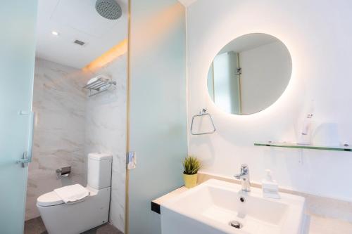 新加坡Hotel NuVe的白色的浴室设有水槽和镜子