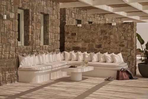 埃利亚海滩Yi Hotel Mykonos的客厅配有白色沙发,靠砖墙