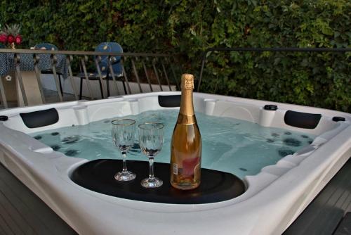 斯普利特卡Seaview Residence的热水浴池内的一瓶香槟和两杯酒