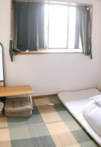 大阪HOSTEL198 Private Room of Third floorーVacation STAY68050v的客房设有床、窗户和桌子。