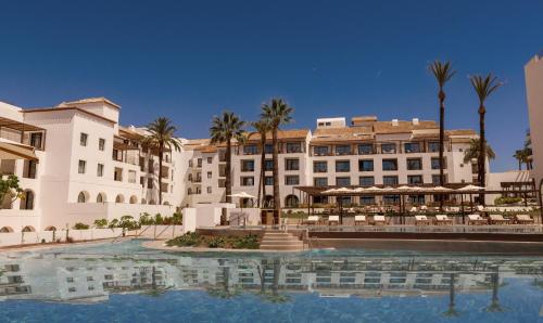 米哈斯La Zambra Resort GL, part of The Unbound Collection by Hyatt的大楼前有游泳池的酒店