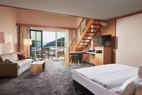 巴特欣德朗奥贝吉奥池全景酒店的一间酒店客房,设有一张床和一个楼梯