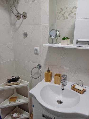大格拉迪什泰Apartman Silver Lux Srebrno jezero的浴室设有白色水槽和镜子