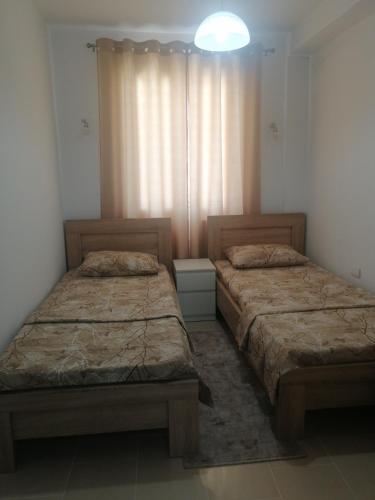 乌尔齐尼Dizara Apartman's的卧室内两张并排的床