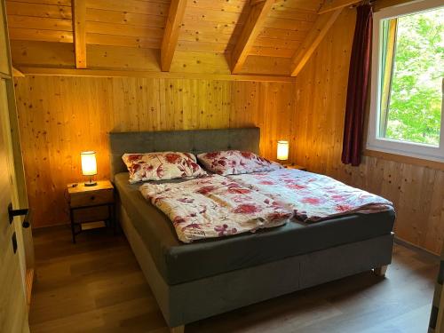 穆劳附近圣洛伦岑Alpenferienhaus Sophia的一间卧室配有一张带两盏灯的床和一扇窗户。