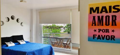 布宜诺斯艾利斯DaHause - Monoambiente en cañitas的一间卧室设有蓝色的床和一个阳台