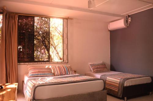 里奥阿查Yosu Hostal的客房设有两张床和窗户。