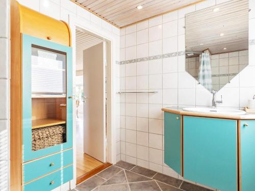 KarrebæksmindeHoliday home Karrebæksminde IX的一间带水槽和蓝色橱柜的浴室