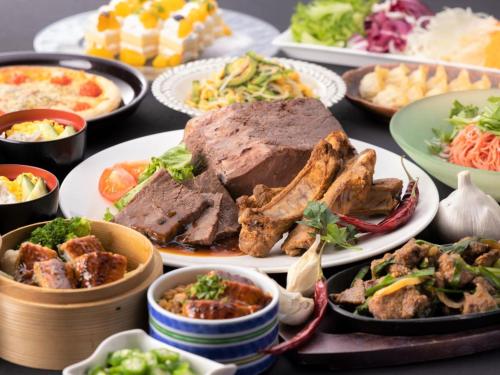 富山富山皇冠假日酒店&度假村的餐桌,盛满食物,包括肉类和蔬菜