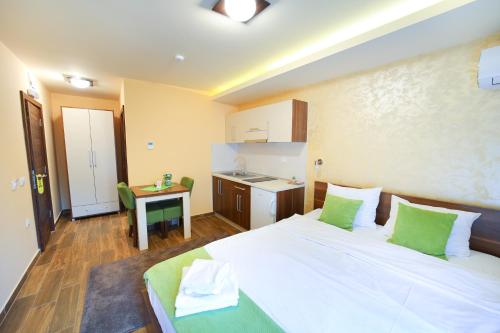 索科矿泉村Vila Almax的卧室配有带绿色枕头的大型白色床