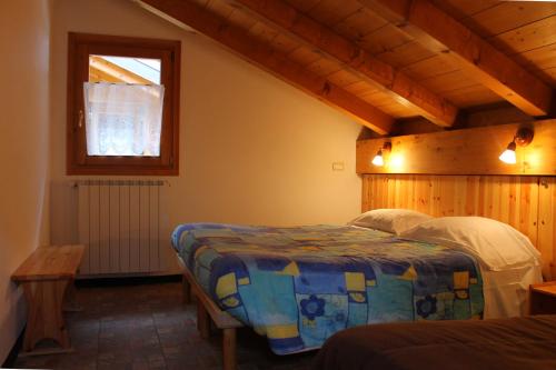 泰穆Chalet Presanella的一间卧室设有两张床和窗户。