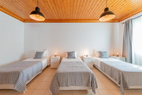 圣罗克杜皮库Prainha Apartments的客房设有两张床、两盏灯和一个窗户。