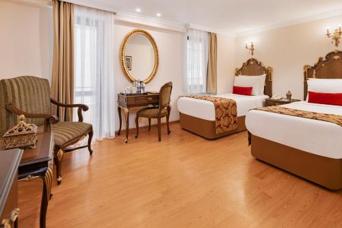 安卡拉怡凯乐酒店的酒店客房,设有两张床和镜子