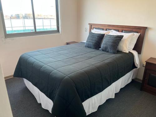 圣佩德罗德拉帕斯Departamento full equipamiento的一间卧室配有一张带蓝色棉被的大床