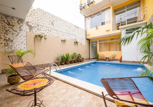 伊基托斯102 RV APARTMENTS IQUITOS-APARTAMENTO FAMILIAR CON PISCINA的房屋中间的游泳池