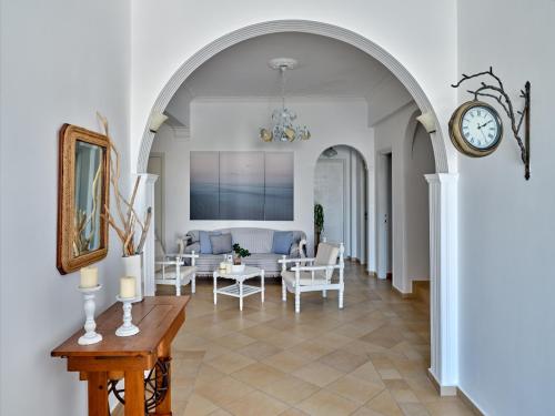 纳乌萨嘉里尼酒店的带沙发和时钟的客厅中的拱门