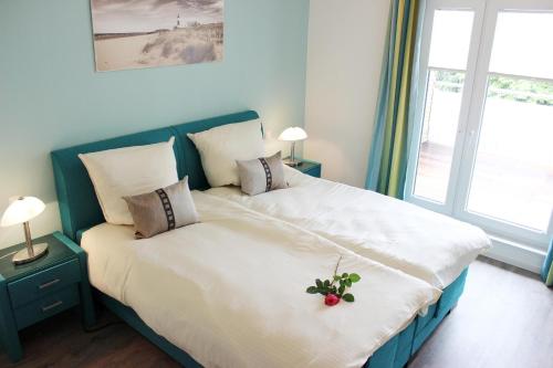 格洛米茨Penthouse Parkblick的一间卧室配有一张大床,床上放着鲜花