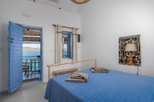 KlimaBlue Horizon Syrma的一间配备有蓝色床的卧室,享有海景