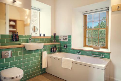 Forest MillSlackbrae的带浴缸、盥洗盆和卫生间的浴室