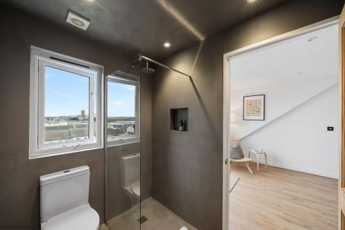 纽基Stylish & Modern Home, Central Newquay w/parking的一间带卫生间和窗户的浴室