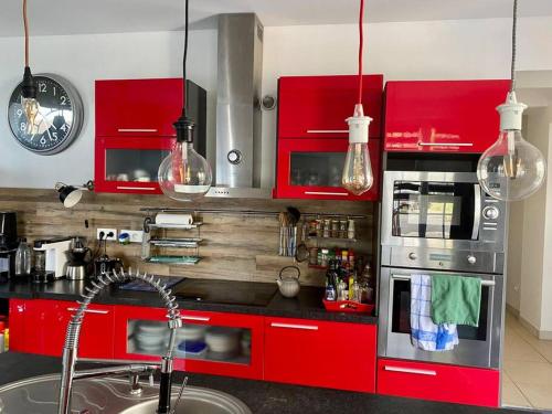 卡布尔kerwatt的一间厨房,配有红色橱柜和台面