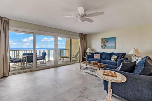 阿米莉亚岛Oceanfront w Beach Access的一间带蓝色沙发的客厅和一个阳台