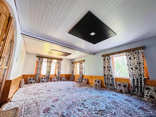 古尔马尔格Sheen Homestay的一间空房,配有椅子和大地毯