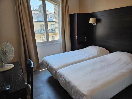 巴黎贝尔维尤和黄金战车酒店的配有窗户的酒店客房内的两张床