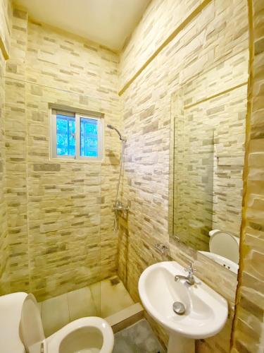 拉罗马纳Green Oasis Hotel的浴室配有白色卫生间和盥洗盆。