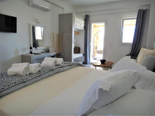 图罗斯Megusta Mykonos的白色卧室配有一张带枕头的大白色床