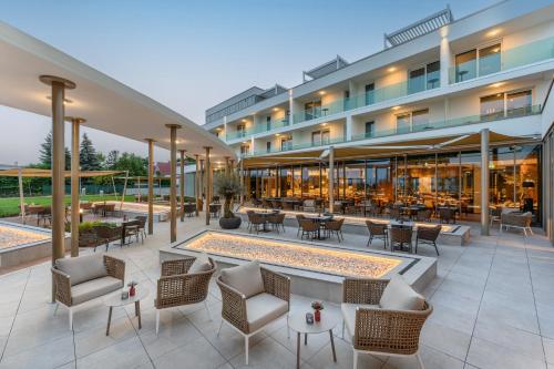 巴拉顿菲赖德Hotel Vinifera Wine & Spa 5 Stars Superior的享有酒店外景,配有桌椅