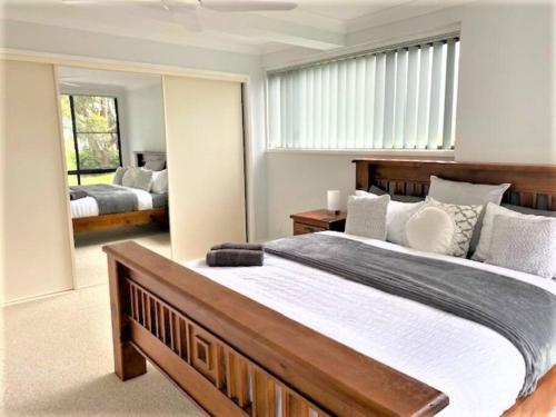 萨拉曼德湾Wanda House - Close to beach Linen Pets的一间卧室设有一张大床和一个大窗户