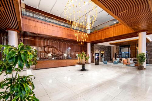 巴库巴库假日酒店的带有植物和吊灯的酒店大厅
