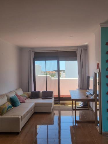 维拉Ático Loft Vera Playa的带沙发和大窗户的客厅