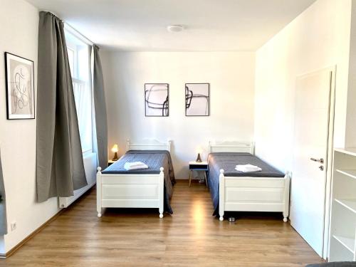 杜伊斯堡2 Rooms, free Parking, 25 min to Düsseldorf, 150 Mbps WLAN的带2扇窗户的客房内的2张床