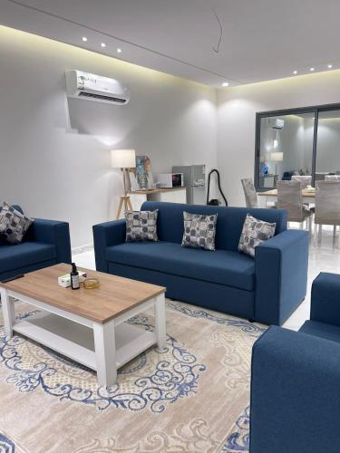 艾卜哈جناح فندقي في فله خاصة的客厅配有蓝色的沙发和咖啡桌