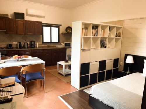 莫托拉AL Ribeirinho的一间带一张床的房间和一间带桌子的厨房